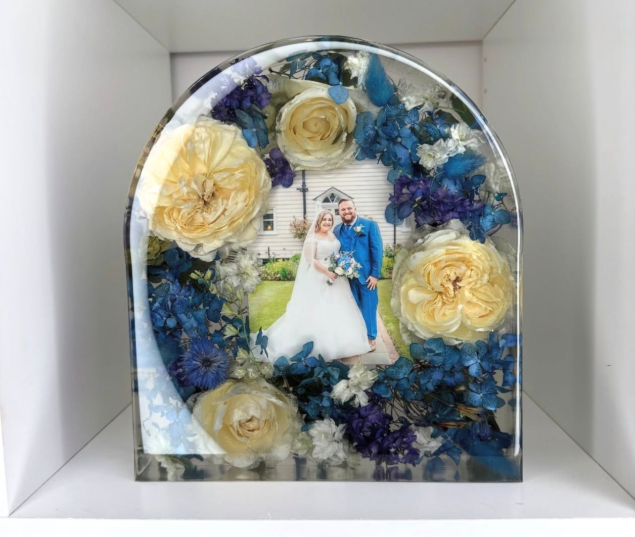 Blue and ivory floral photo arch with wedding portrait